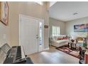 Living room with off-white couch, tiled floors, and a piano at 4741 Park Eden Cir, Orlando, FL 32810