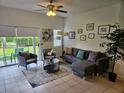 Living room with grey sectional sofa and access to backyard at 969 Park Terrace Cir, Kissimmee, FL 34746