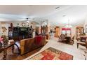 Spacious living room with hardwood floors, leather furniture, and a large entertainment center at 3500 Sail Fish Ave, Fruitland Park, FL 34731