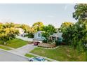 Two-story house with a landscaped yard and driveway, seen from above at 3500 Sail Fish Ave, Fruitland Park, FL 34731