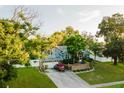 House with a two-car garage and lush landscaping at 3500 Sail Fish Ave, Fruitland Park, FL 34731