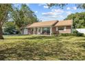 Ranch style home with a large front yard and mature trees at 1421 Avenue G Ne, Winter Haven, FL 33881