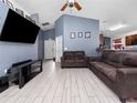 Spacious living room with two brown couches and a large TV at 9920 4Th Ave, Orlando, FL 32824