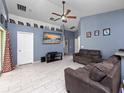 Living room featuring two couches, a large TV and ceiling fan at 9920 4Th Ave, Orlando, FL 32824