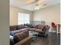 Spacious living room with a large sectional sofa and a glass coffee table at 3194 Mapleshade St, Deltona, FL 32738