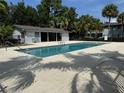 Community pool with surrounding patio and building at 4815 S Texas Ave # C, Orlando, FL 32839