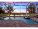Relaxing pool and spa with view of lake and homes at 453 Ocean Course Ave, Champions Gate, FL 33896