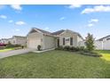 One-story house with green siding, landscaping, and a two-car garage at 7358 Sw 76Th Ter, Ocala, FL 34481