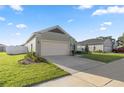 House exterior showcasing a two-car garage and well-manicured lawn at 7358 Sw 76Th Ter, Ocala, FL 34481