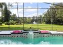 Relaxing pool and spa with screened enclosure and fountain at 256 New Gate Loop, Lake Mary, FL 32746