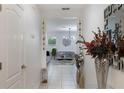 Hallway view into living room with modern chandelier at 3400 Mt Vernon Way, Kissimmee, FL 34741