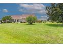 Landscaped front yard with spacious lawn and mature trees at 2228 Sylvan Ct, Kissimmee, FL 34746