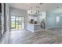 Open concept kitchen with breakfast bar and view to backyard at 2228 Sylvan Ct, Kissimmee, FL 34746