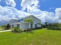 Modern townhome with gray siding, landscaping, and a spacious yard at 7924 Spectrum Dr, Kissimmee, FL 34747
