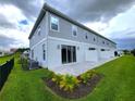Townhome rear elevation with patio and fenced backyard at 7924 Spectrum Dr, Kissimmee, FL 34747