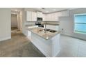 Modern kitchen featuring a large island with granite countertops and white cabinets at 4197 Sagefield Dr, Harmony, FL 34773