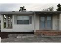 White stucco house with double doors and covered porch at 1106 N Hoagland Blvd, Kissimmee, FL 34741