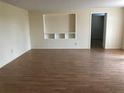 Living room featuring hardwood floors and built-in shelving at 1106 N Hoagland Blvd, Kissimmee, FL 34741