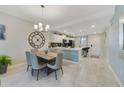 Open concept kitchen with island, stainless steel appliances, and dining area at 4751 Clock Tower Dr # 105, Kissimmee, FL 34746