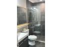 Modern bathroom with a glass shower and gray tile at 13427 Blue Heron Beach Dr # 501, Orlando, FL 32821