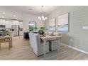 Modern dining area with light beige chairs and a view into the kitchen at 300 Barebow Ln, Ormond Beach, FL 32174