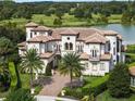 Luxury home situated on a spacious lot with a lake view at 25602 Grandview Pointe, Sorrento, FL 32776