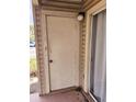 Exterior storage room with a white door and light fixture at 1916 Lake Atriums Cir # 25, Orlando, FL 32839