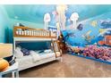 Ocean-themed bedroom with bunk beds and whale mural at 1414 Thunderbird Rd, Davenport, FL 33896