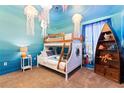 Ocean-themed bedroom with bunk beds and custom mural at 1414 Thunderbird Rd, Davenport, FL 33896