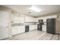 Modern kitchen with white shaker cabinets, granite countertops, and stainless steel appliances at 507 Francis Blvd, Lakeland, FL 33801