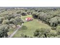 Aerial view of a house with a red roof on a large lot at 14742 Sw 4Th Ave, Ocala, FL 34473