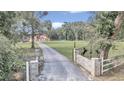 Long driveway leading to a single-story house in a wooded area at 14742 Sw 4Th Ave, Ocala, FL 34473