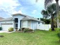 Front view of house showing garage, landscaping and fence at 1640 Mountclair Ct, Mount Dora, FL 32757