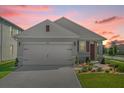 Nice curb appeal! This single-story home features a 2-car garage and neutral exterior at 6760 Huntleigh Hammock Rd, Harmony, FL 34773