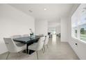 Spacious dining area with a six-chair table, looking toward the living room at 6760 Huntleigh Hammock Rd, Harmony, FL 34773