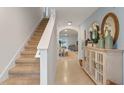 Bright entryway with staircase, tile flooring, and decorative console table at 2924 Waterlily Way, Poinciana, FL 34759
