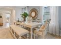 Dining area with white table, bench seating, and soft blue walls at 2924 Waterlily Way, Poinciana, FL 34759