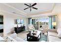 Spacious living room with large TV, comfortable seating, and access to balcony at 1100 Sunset View Cir # 203, Reunion, FL 34747
