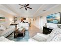 Spacious living room with light flooring, comfortable sofas, and large TV at 1100 Sunset View Cir # 203, Reunion, FL 34747