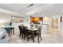 Bright dining area featuring a wood table and chairs at 1100 Sunset View Cir # 203, Reunion, FL 34747