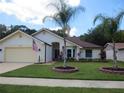 Front view of a single-story house with a landscaped yard at 11540 Sandy Hill Dr, Orlando, FL 32821