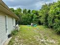 Large backyard with a seating area and lush greenery at 1501 Fort Smith Blvd, Deltona, FL 32725