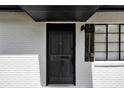 Modern black front door with white brick exterior at 2512 Golfview St, Lakeland, FL 33801