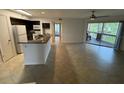 Open living room and kitchen with granite countertops at 470 S Pin Oak Pl # 204, Longwood, FL 32779
