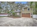 Two-story house with a large driveway and landscaped front yard at 734 S Mills Ave, Orlando, FL 32801