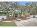 Two-story house with a large driveway and landscaped front yard at 734 S Mills Ave, Orlando, FL 32801