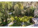 Mature trees and landscaped gardens surround the home at 1391 Richmond Rd, Winter Park, FL 32789