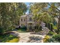 Brick home nestled in lush landscaping, large driveway at 1391 Richmond Rd, Winter Park, FL 32789