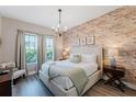 King bedroom with brick feature wall and ensuite at 2602 Sunrise Shores Dr, Kissimmee, FL 34747
