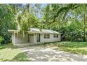 One story house with carport and green door at 104 E Mcclendon St, Lady Lake, FL 32159